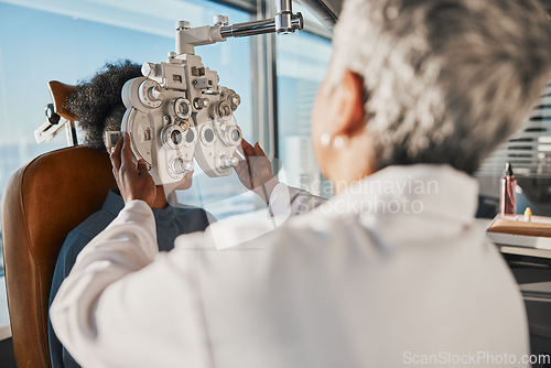 Image of Optometry, eyecare and optician doing a eye test for a patient for vision or healthcare in a clinic. Ophthalmology, medical and female optometrist doing exam for prescription lenses in optical store.