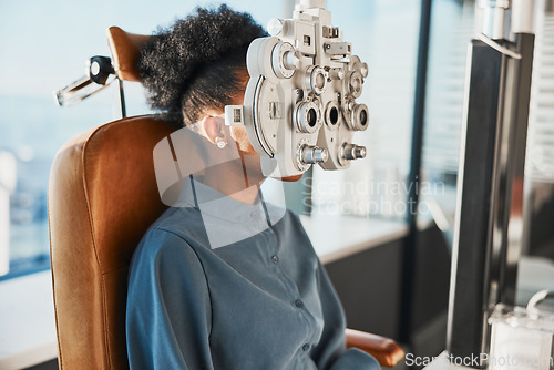 Image of Healthcare test, eye exam and black woman in optometry clinic for testing, eyesight and optical assessment. Vision, optometrist consultation and patient with medical tool, phoropter and lens for eyes