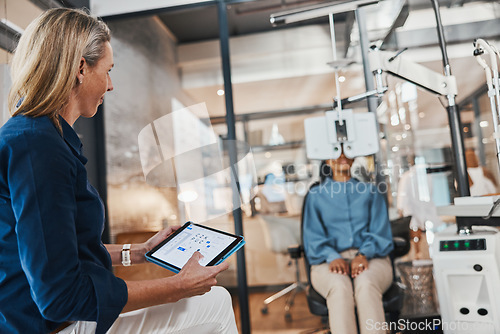 Image of Eye exam, woman doctor tablet and consulting optometrist with patient at clinic. Eyes wellness worker, healthcare and vision exam with tech and digital results from glaucoma consultation machine