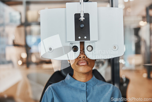 Image of Vision, eye exam and black woman in optometry clinic for testing, eyesight and optical assessment. Healthcare, optometrist consultation and patient with medical equipment, phoropter and lens for eyes