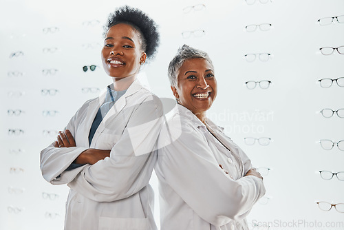 Image of Optometry, healthcare and portrait of optometrists in a clinic after optic consultation or eye test. Leadership, ophthalmology and team of women opticians standing with crossed arms in optical store.