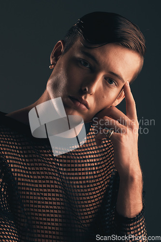 Image of Gender neutral person, fashion and portrait on dark background, trendy and edgy. Creative, gen z and thinking with beauty, sexy with cosmetics and serious, non binary and designer clothes in studio
