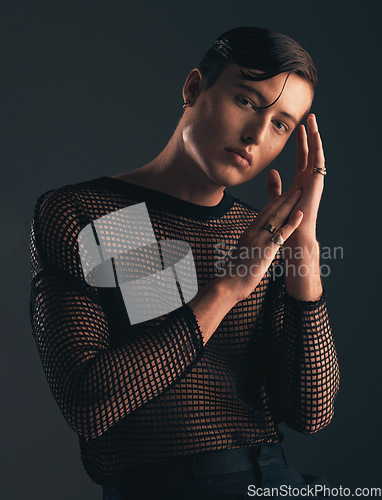 Image of Gender neutral, face and fashion, portrait on dark background and trendy, edgy with hands. Creative, gen z and beauty, sexy and cosmetics with serious non binary person in designer clothes