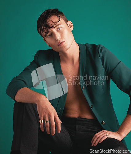 Image of Gen z, fashion model portrait and non binary person with designer clothing with green background. Isolated, studio and modern hipster clothes of an lgbtq and serious adult with youth and cool style