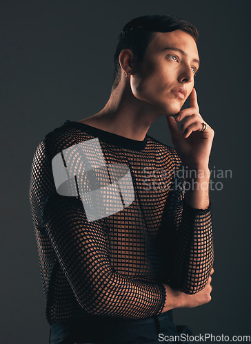 Image of Gender neutral person, fashion and thinking on dark background, trendy and edgy art. Creative, gen z and beauty, queer and sexy with cosmetics, contemplating with non binary and designer clothes