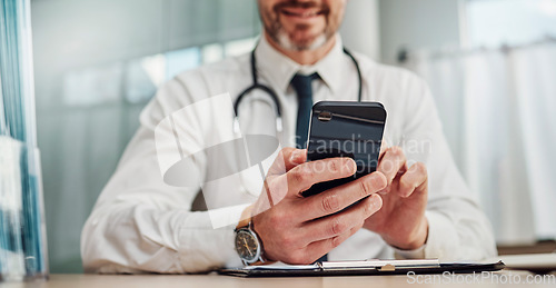 Image of Healthcare, hospital and hands of doctor with phone for social media, research and online consulting. Communication, insurance and man with smartphone for wellness app, medical data and telehealth
