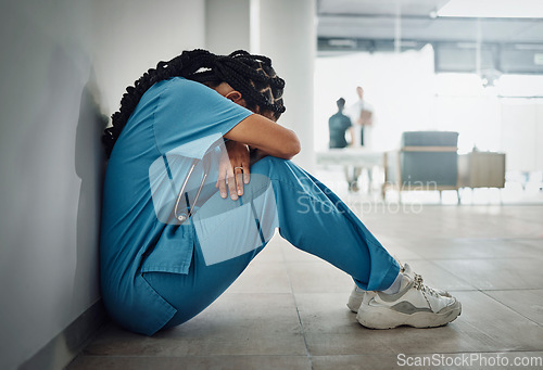 Image of Doctor, depression and stress with black woman on floor for patient loss, surgery fail or death in hospital. Mental health, sad or anxiety for healthcare worker nurse in medical community clinic