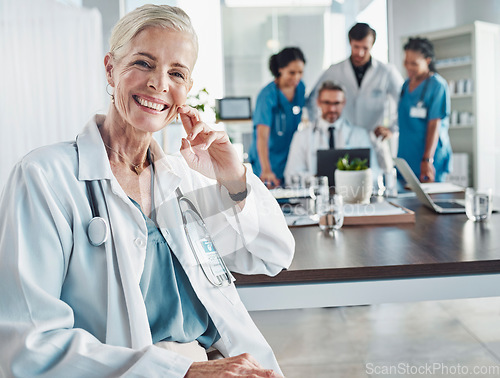 Image of Healthcare, smile and leadership, portrait of woman doctor at desk in hospital for support, teaching and medical students. Health, medicine and confident, mature and happy mentor with stethoscope.