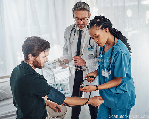 Image of Doctor, nurse and patient with blood pressure test in hospital for heart health or wellness. Healthcare, hypertension consultation and medical physician with man for examination with sphygmomanometer