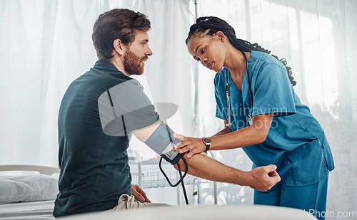 Image of Nurse, doctor and man with blood pressure test in hospital for heart health or wellness. Healthcare, hypertension consultation and medical physician with patient for examination with sphygmomanometer