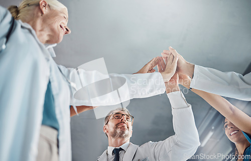 Image of Doctor, team and high five in celebration for healthcare success, good job or winning in collaboration at clinic. Hands of medical experts in teamwork celebrating achievement, agreement or goals