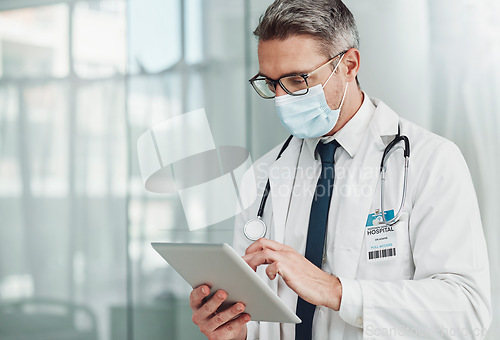 Image of Hospital, research and doctor with tablet and mask for wellness, medical care and patient data. Healthcare, insurance and senior man on digital tech for online consulting, report and telehealth app