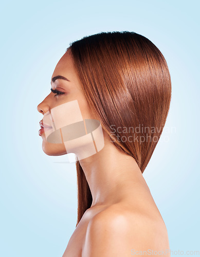 Image of Face, hair care and skincare of woman in studio isolated on a blue background. Hairstyle cosmetics, thinking and profile of young female model with salon treatment for growth, texture and balayage.