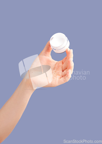 Image of Skincare, hands and cream container in studio isolated on a purple background for hydration. Cosmetics, dermatology and woman or female model with lotion, creme or moisturizer for beauty aesthetics.