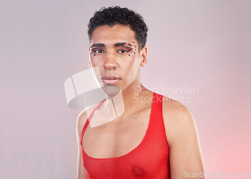 Image of Fashion, makeup with portrait of gay man for freedom, gen z and design. Creative, aesthetic and cosmetics with serious queer model for lgbtq, gender identity and beauty in pink background studio