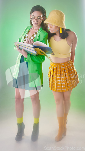 Image of Vintage woman students, books and studio with 80s fashion, retro and learning together with trippy green aesthetic. Gen z model friends, clothes and teacher cosplay with reading by blurred background
