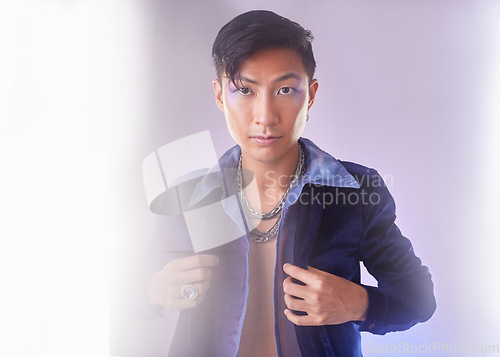 Image of Makeup, light and portrait of gay man from Indonesia with confidence isolated on purple background. Style, aesthetic and lgbt fashion model with beauty in studio, non binary and gender neutral design
