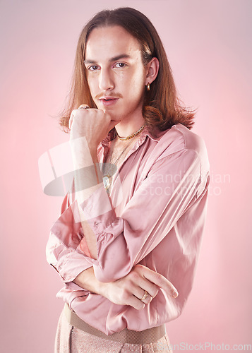 Image of Portrait, retro fashion and lgbt man, pride and confidence isolated on pink background. Style, aesthetic and art, gay male model in beauty and creative non binary and gender neutral design in studio.