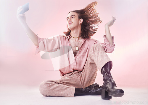 Image of Gen z, man and selfie in studio for fashion, edgy and contemporary style on pink background. Social media, male and trendy influencer with smartphone for blog, podcast or profile picture update