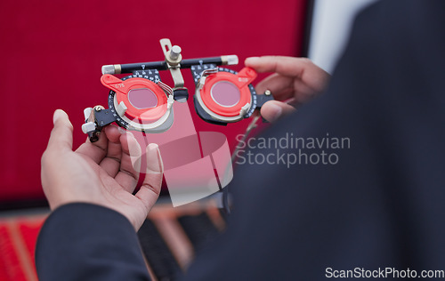 Image of Glasses, lens and trial frame, hands with ophthalmologist tools, vision test with woman, healthcare for eyes and prescription. Optometry, eye care and optometrist, medicine and measurement