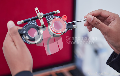 Image of Hands, trial frame and optometry, lens and test, vision and glasses with ophthalmologist tools, healthcare for eyes. Optometry, eye care and optometrist person, medicine and chart with measurement