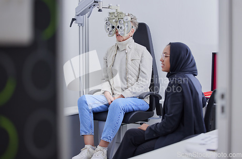 Image of Vision, eye exam and senior woman with optometrist in clinic for testing, eyesight and optical assessment. Optometry, healthcare and Muslim optician with patient, phoropter and medical tool for eyes