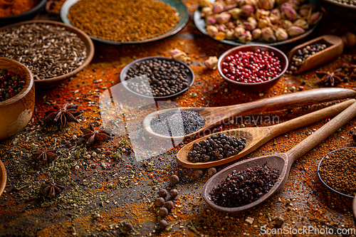 Image of Colorful spices in wooden spoons