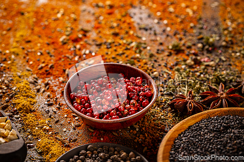 Image of Red peppercorn in wooden bowl