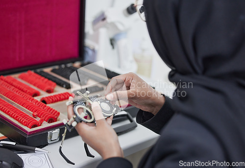 Image of Glasses, lens and test with ophthalmologist tools, trial frame with woman hands, healthcare for eyes and prescription. Optometry, eye care and Muslim optometrist, medicine and chart with measurement