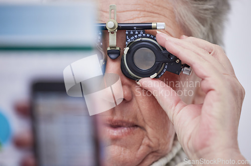 Image of Eye exam, vision and senior woman with lens in clinic for testing eyes, eyesight and optical assessment. Optometry, healthcare and elderly patient reading for optician, medical care and trial glasses