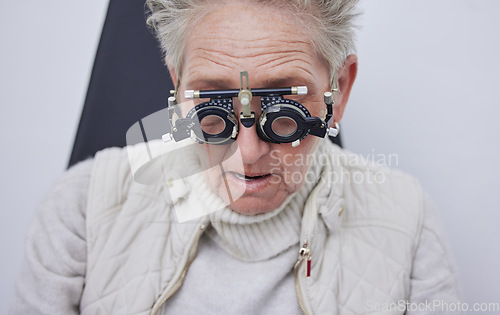 Image of Eye exam, trial frame and senior woman in optometry clinic for vision test, eyesight and optical assessment. Ophthalmology, health and face of elderly patient with optician, optometrist and glasses