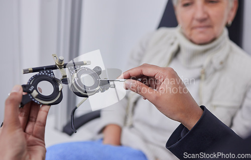 Image of Optometrist hands, test glasses and senior woman for health advice and helping hand in consultation room. Elderly patient, healthcare or doctor for eyes, reading or eyesight in retirement at clinic