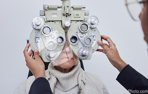 Image of Eyes, vision exam and senior woman with optometrist in clinic for test, eyesight and optical assessment. Optometry, healthcare and optician with elderly patient, phoropter lens and medical machine