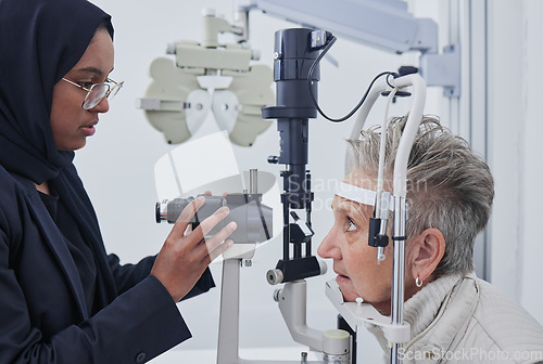 Image of Eye exam, optometrist and senior woman in clinic for test, eyesight and ophthalmology assessment. Optometry, optical healthcare and Muslim optician with patient for testing, medical lens and glasses