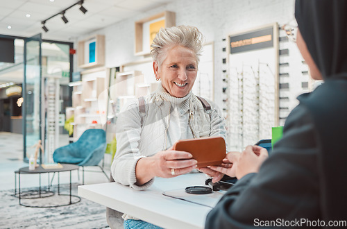 Image of Eye care, senior woman and glasses for patient shopping for vision lens or frame at optics store. Happy customer person talking to service consultant for decision on optometry case choice for eyes