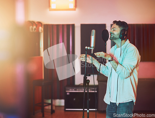 Image of Musician, microphone or singing in studio for album recording, theatre night performance or radio industry. Man, singer or artist with headphones for production, theater melody or jazz karaoke media