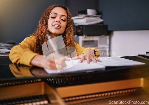 Image of Musician, paper or song writing on piano in recording studio for album recording, concert performance or radio industry. Woman, singer or pianist and artist sheets for production, melody or jazz idea