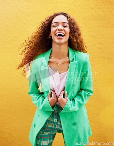 Image of Portrait, fashion and woman laughing on yellow background, color wall and backdrop with smile in Colombia. Happy young female, trendy style and green clothes for beauty, curly hair and gen z model