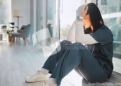 Image of Nurse, depression and woman with stress in hospital after loss, grief or bad news in clinic. Mental health, healthcare and sad female medical physician with burnout, anxiety or headache after nursing