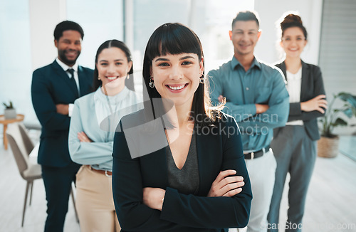 Image of Portrait, collaboration and management with a leader woman and her team standing arms crossed in the office. Vision, teamwork or diversity and a female manager posing at work with her employee group