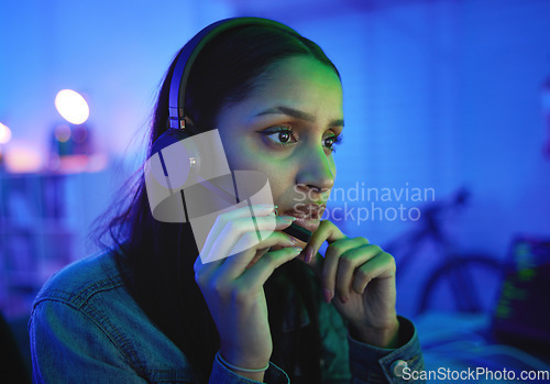 Image of Talking woman, headphones or live streaming in neon home with esports ideas, pro gaming at night with anxiety. Player, headset or gamer microphone in night house with cyberpunk competition channel