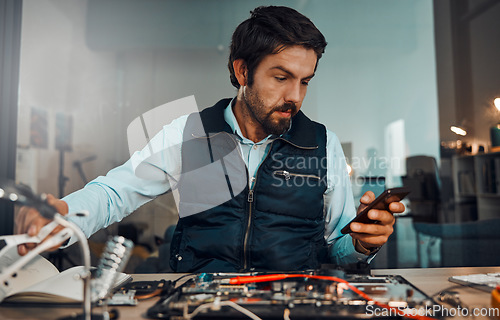 Image of Computer hardware repair, phone and it worker watch a diy video to fix a semiconductor and circuit. Engineering, workshop and electric work of a male engineer with a mobile doing electrical project