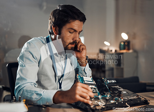 Image of Technology, repair and thinking with an man fixing a device in an office for electrical or engineering. Laptop, information technology and service with a male it professional working on maintenance
