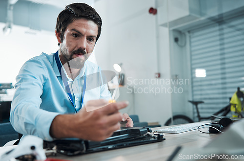 Image of Laptop, repair and screwdriver with an engineer or handyman fixing hardware in an IT office. Computer, information technology and maintenance with a male service professional at work on technology