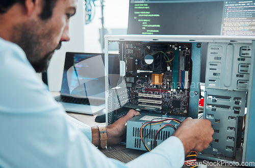 Image of It technician, engineer and computer hardware with a man working to fix or maintenance technology. Hands of expert IT person in office data center for system repair, engineering or motherboard update
