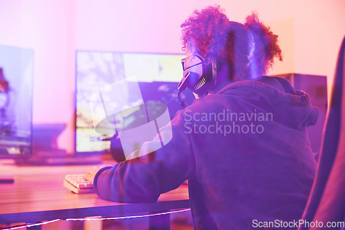 Image of Back of girl, gamer and computer in home, desk or online games of virtual competition. Female streamer, live streaming and night gaming with headphones in neon lighting and esports technology