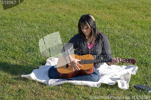 Image of Girl Playing a Guitar