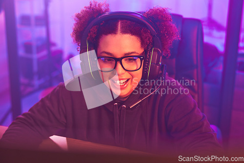 Image of Video game, teenager girl and headphones in home for esports, online games and virtual player. Female gamer, computer live streaming and gaming with headset in neon lighting, tech and gen z streamer