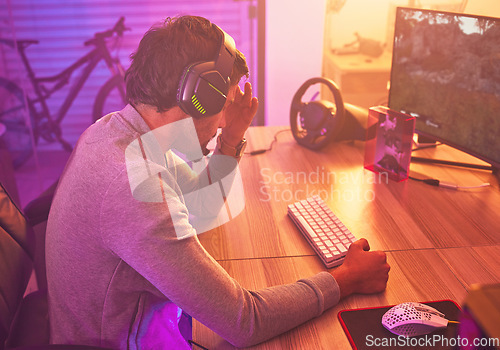 Image of Headache, gamer or man on computer with depression from loss, fail or online competition tournament anxiety in room. Neon, sad or male stress for gaming mental health, live stream or esport glitch