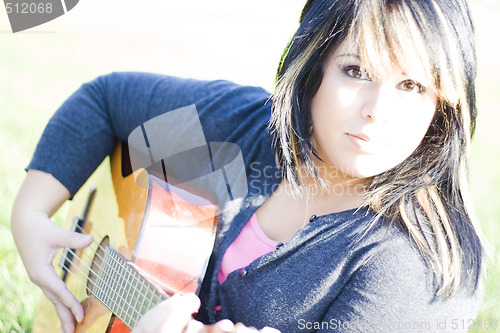 Image of Girl Playing a Guitar